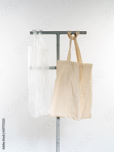 plastic bag vs eco natural reusable bag for shopping, flat lay on white background. Sustainable lifestyle concept. Zero waste. Reduse plastic free items.