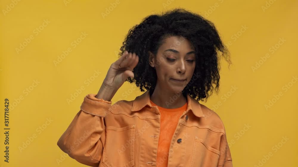 dissatisfied african american woman showing blah blah gesture isolated on yellow dissatisfied african american woman showing blah blah gesture isolated on yellow