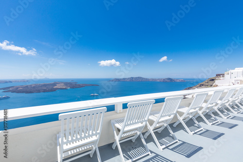  Santorini island. Romantic white chairs on white caldera with sea view. Luxury travel and vacation destination. Amazing summer landscape  sea view. Perfect tourism poster template  copyspace 