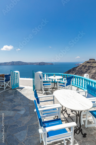  Santorini island. Romantic white chairs on white caldera with sea view. Luxury travel and vacation destination. Amazing summer landscape, sea view. Perfect tourism poster template, copyspace 