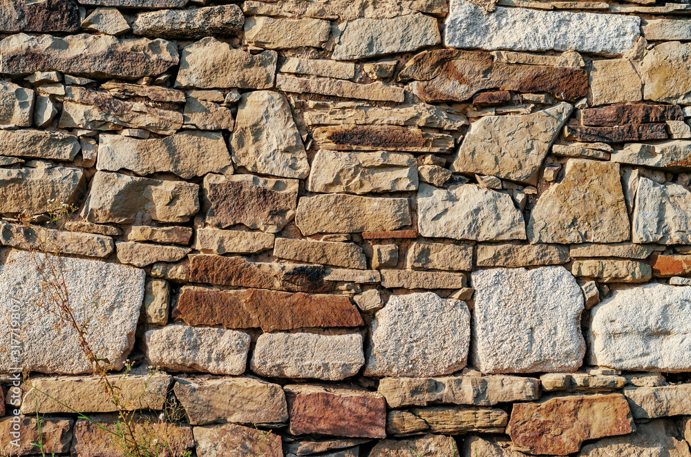 Wall made of old stones of different sizes Wall made of old stones of different sizes