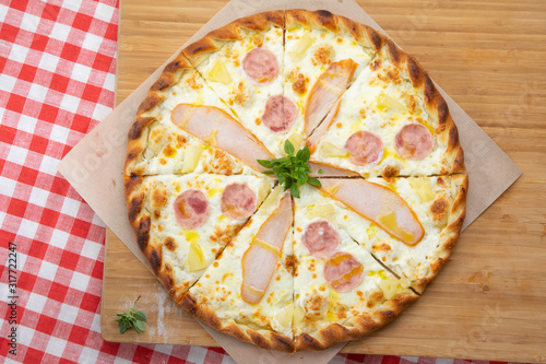 Pizza with chicken and ham close-up with various ingredients decorated with Basil, an assortment of traditional Italian fast foods