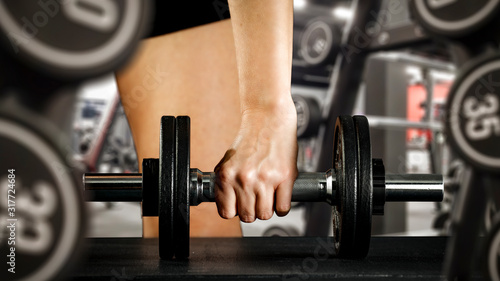 Desk of free space and closeup of woman body in gym interior 