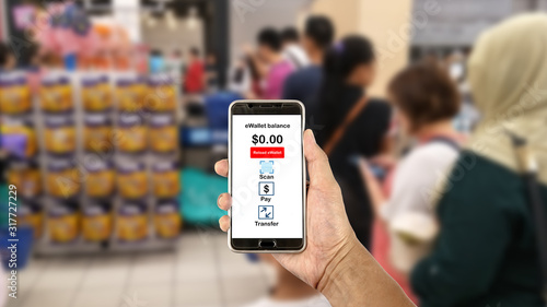 Smartphone with E Wallet app while queuing at the cashier counter. 