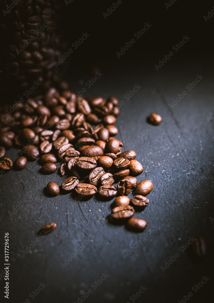 closeup of coffee beans on dark background closeup of coffee beans on dark background