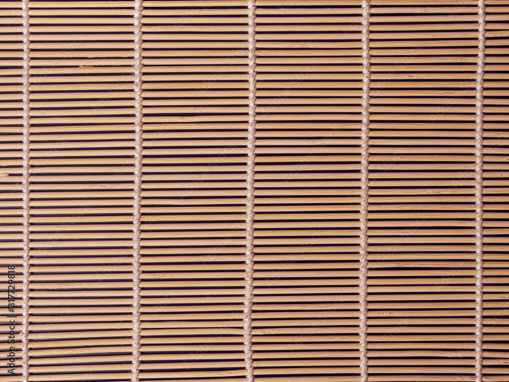 Empty Asian Food Background. brown Bamboo mat on black wooden background top view with copy space flat lay. Empty Asian Food Background. brown Bamboo mat on black wooden background top view with copy space flat lay.