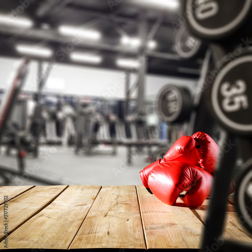 Gym interior and desk of free space.Red boxing gloves and copy space. 
