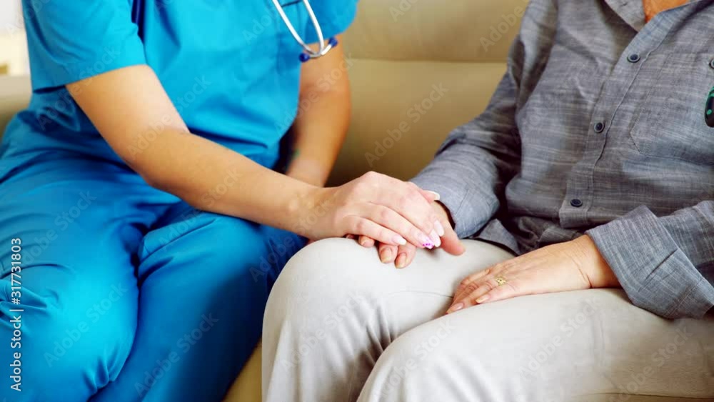 Close up of female caretaker in nursing home holding senior woman hand Close up of female caretaker in nursing home holding senior woman hand