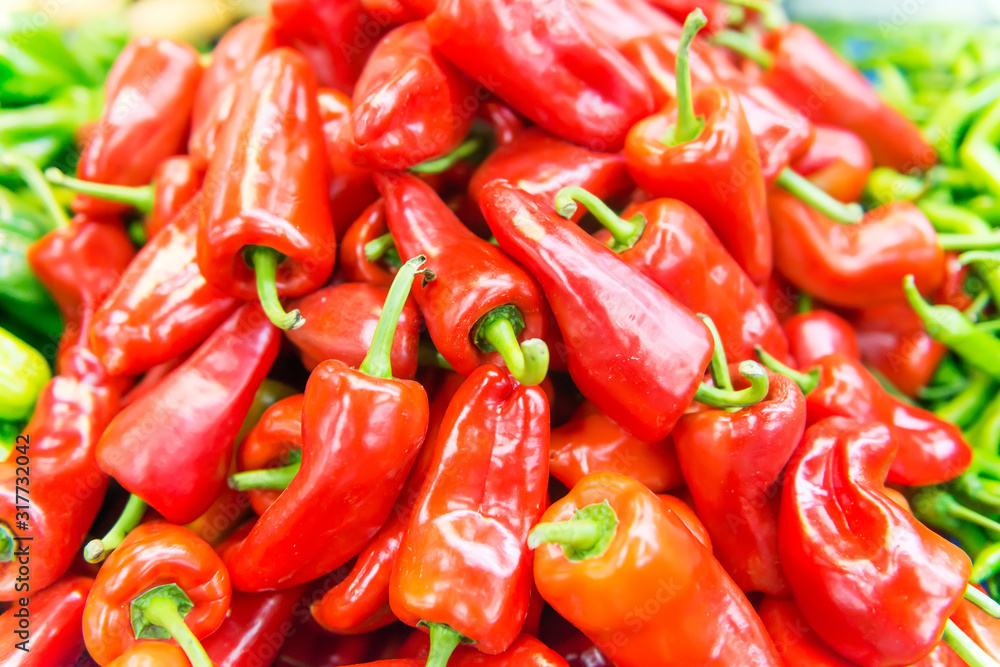 Display of locally grown red bell peppers for sale at local farmers market Display of locally grown red bell peppers for sale at local farmers market