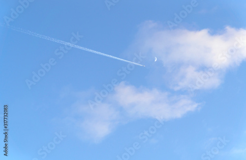 Clouds and blue sky on summer with airplane and moon.