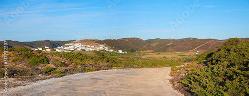 country road through dune landscape, Costa Vicentina, view to Carrapateira holiday resort, Protugal