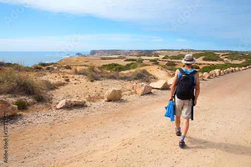 hiker on ccoastal road near Carrapateira, dune landscape West Algarve Portugal
