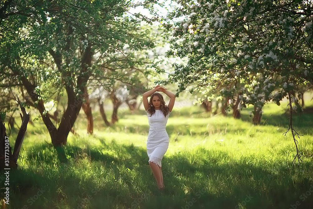 light portrait of an apple tree, girl portrait of a high key, spring mood freshness and purity blonde with long hair in a blooming park in the spring light portrait of an apple tree, girl portrait of a high key, spring mood freshness and purity blonde with long hair in a blooming park in the spring