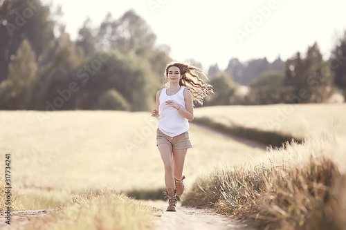 happy young adult model in yellow wheat field / summer happiness concept girl in the field
