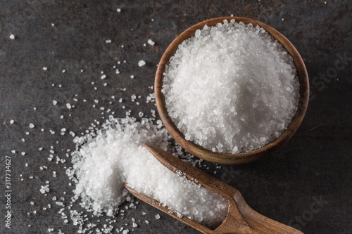Crystaline sea salt in bowl and spoon - closeup