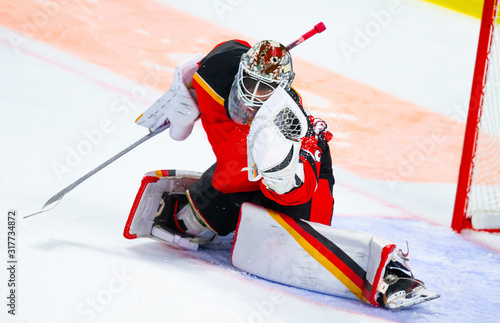 Ice hockey goalie makes a great glove save photo