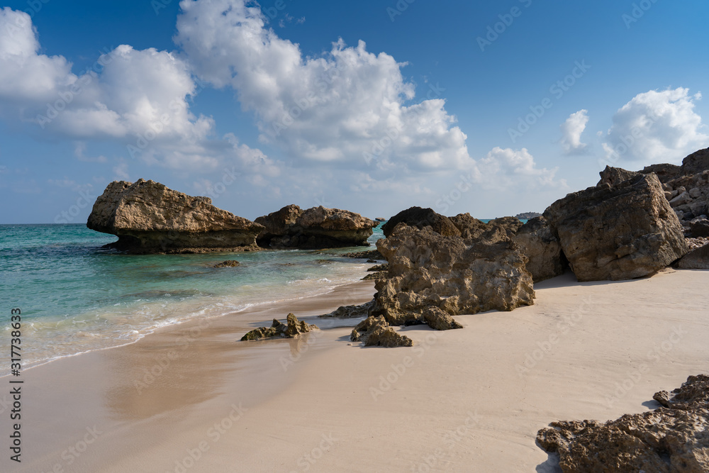 Fazayah Beach, Salalah Oman, Fantastic seascape, great outdoor scene of Beauty of nature concept background, blue sea, few clouds, light sandy beach, rocks in the water