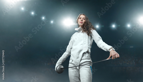Konstfotografi Female fencer on professional sports arena.