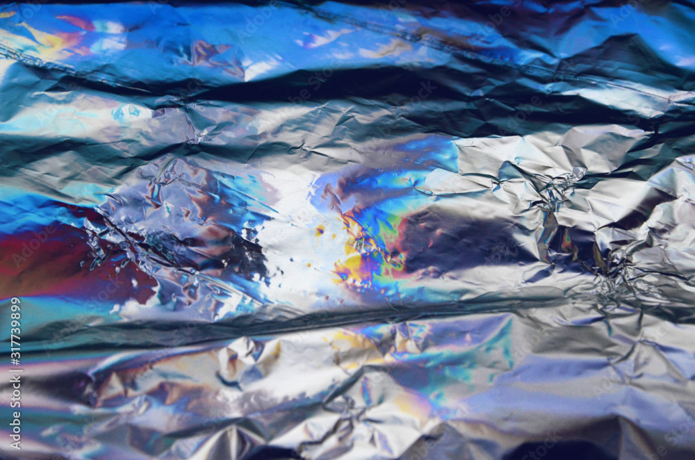 Fototapeta premium Holographic iridescent crumpled foil texture background