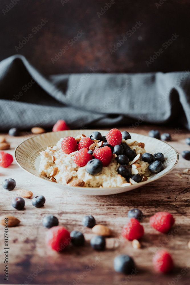 Porridge bowl, oat meal with blueberries, raspberries and almond splits Porridge bowl, oat meal with blueberries, raspberries and almond splits