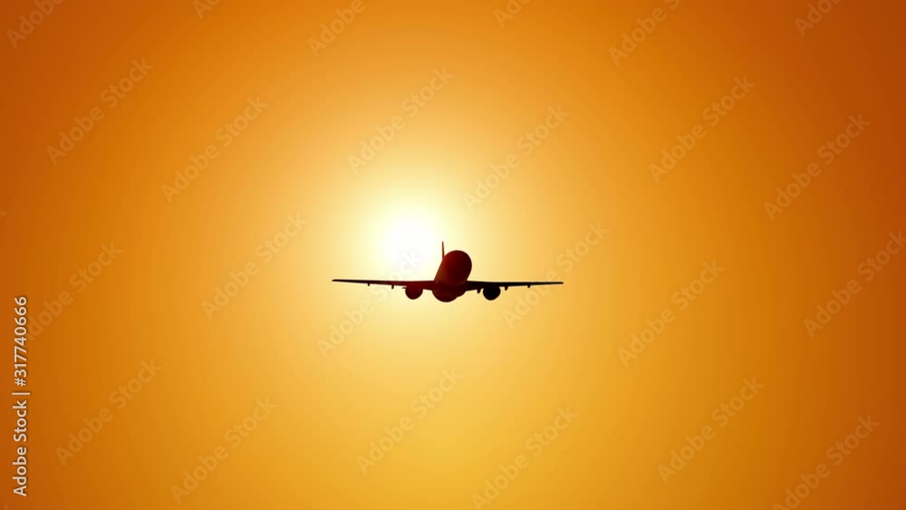 A large passenger plane takes off against the background of a sunset. Orange backgrand..Super slow motion.