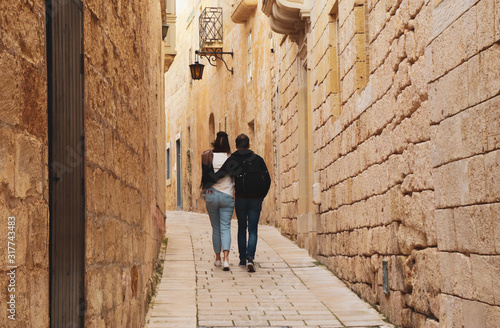 couple have a romantic walk in a old street in european town  horizontal  copy space