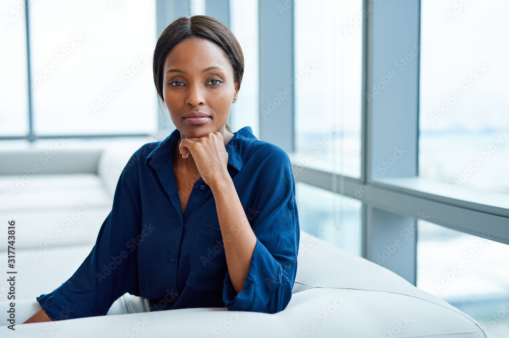 Focused and successful young businesswoman sitting in a modern office