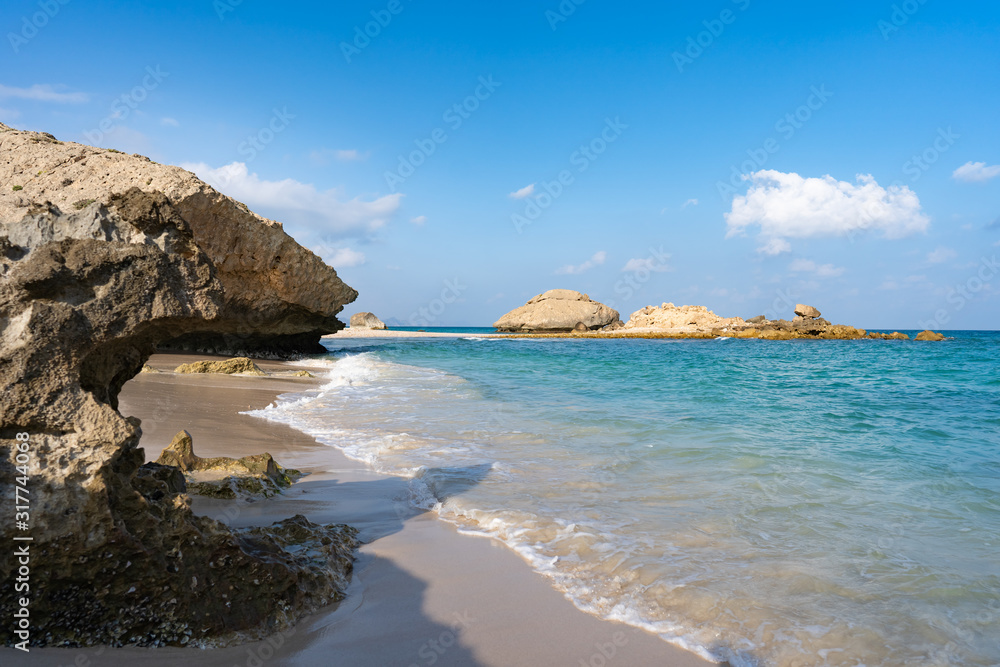 perfect view on the lonely Fazayah Beach, Salalah Oman, Fantastic seascape, great outdoor scene of Beauty of nature concept background, blue sea, few clouds, light sandy beach, rocks in the water perfect view on the lonely Fazayah Beach, Salalah Oman, Fantastic seascape, great outdoor scene of Beauty of nature concept background, blue sea, few clouds, light sandy beach, rocks in the water