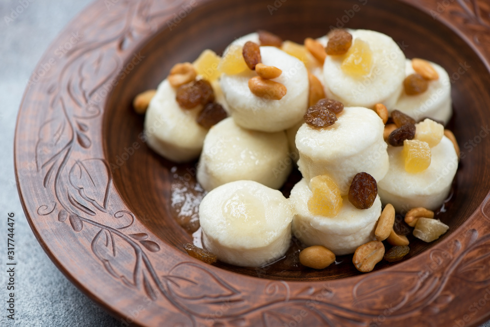 Closeup of steamed vareniki or dumplings made of cottage cheese in a clay plate, selective focus Closeup of steamed vareniki or dumplings made of cottage cheese in a clay plate, selective focus