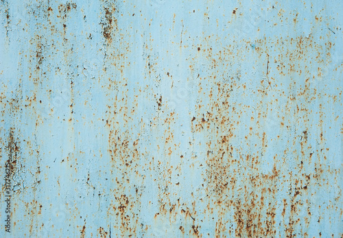 Old faded light blue metal with peeling paint, small spots of rust and scratches. Abstract background, texture.
