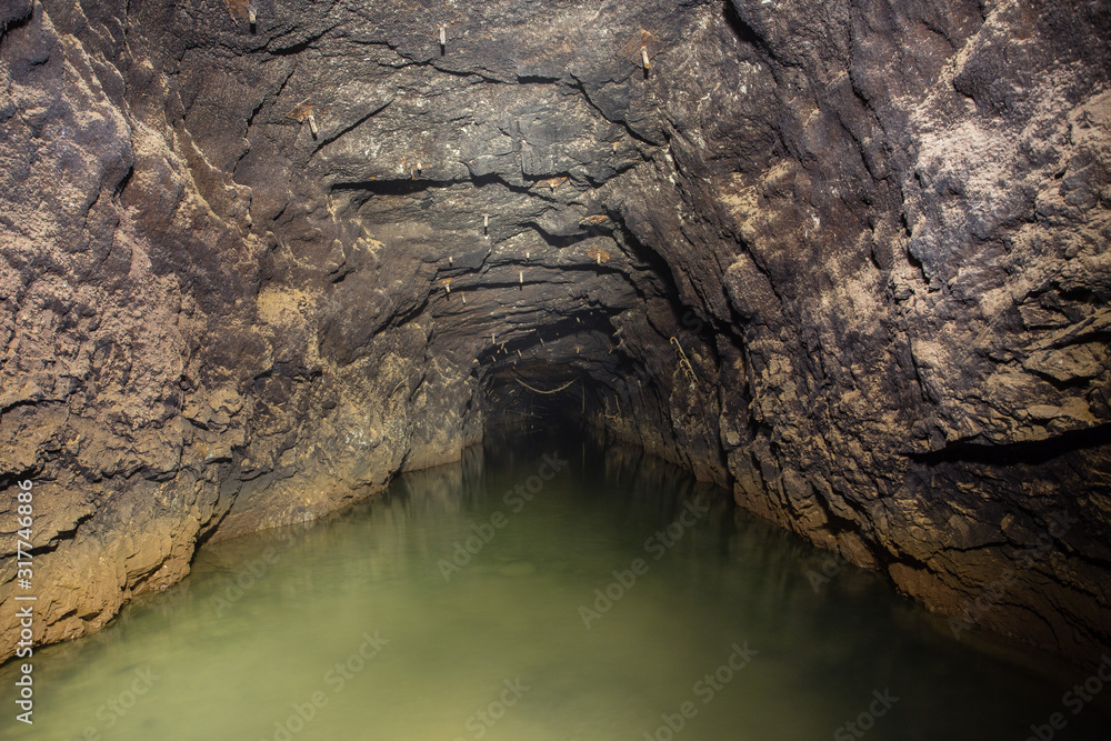 Underground gold ore mine tunnel drowned water Underground gold ore mine tunnel drowned water