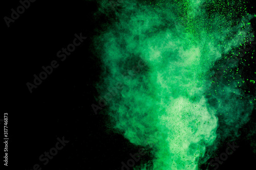 green colorful holi paint explosion on black background