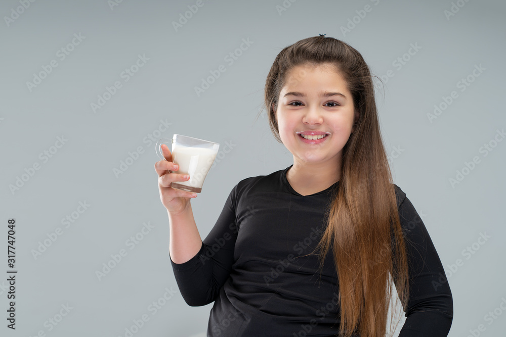 overweight girl holding a glass of milk, smiling. healthy diet . childhood obesity overweight girl holding a glass of milk, smiling. healthy diet . childhood obesity