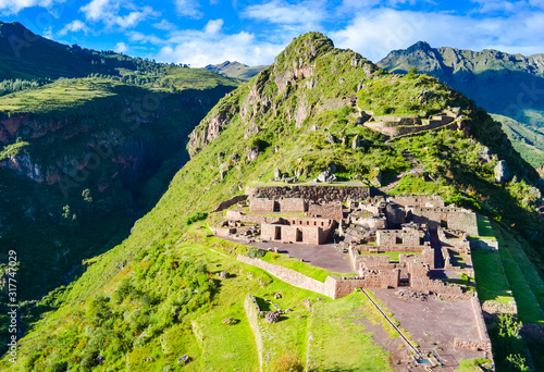 Old inca Pisac town ruins in Peru on the green hill