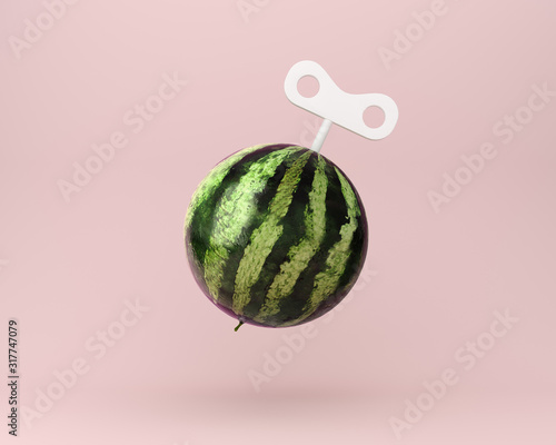 Картината върху платно Creative idea wind up key with watermelon on pastel pink background
