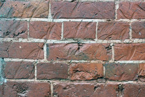 Texture of red bricks with dents and cement