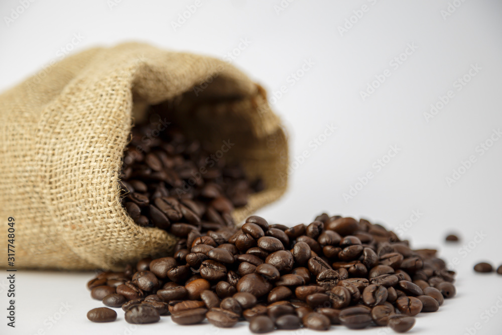 Fototapeta premium Roasted coffee beans In sacks and on the floor