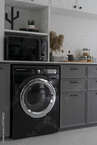 Interior of modern kitchen with washing machine. 