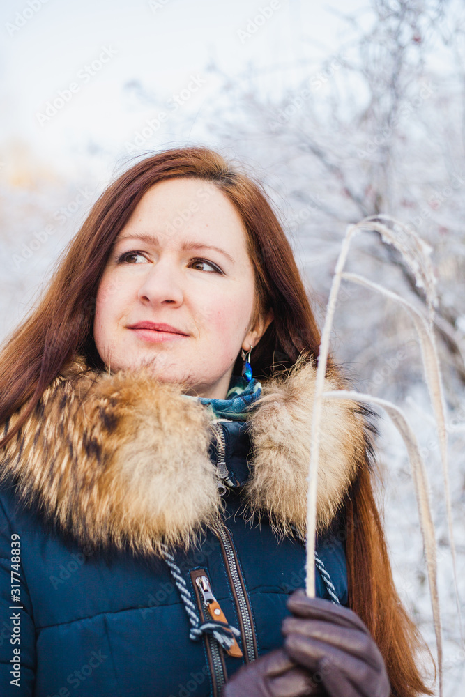 Girl of European appearance on a walk in the winter forest, Park, winter and snow, health, winter clothes, jacket Girl of European appearance on a walk in the winter forest, Park, winter and snow, health, winter clothes, jacket