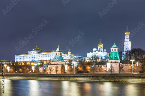 Illuminated Moscow Kremlin with Grand Kremlin Palace the government residence of president of Russia. View from the embankment of Moskva river. Evening urban landscape in the blue hour