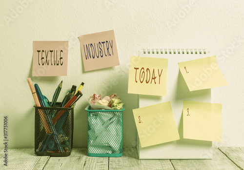 Word writing text Textile Industry. Business photo showcasing production and distribution of yarn cloth and clothing 6 Sticky Notes on Wall Open Spiral Notebook 2 Pencil Pots on Work Desk photo