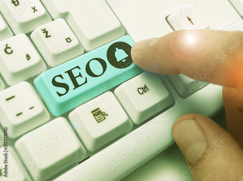 Writing note showing Seo. Business concept for incredibly effective way to market your near business online photo