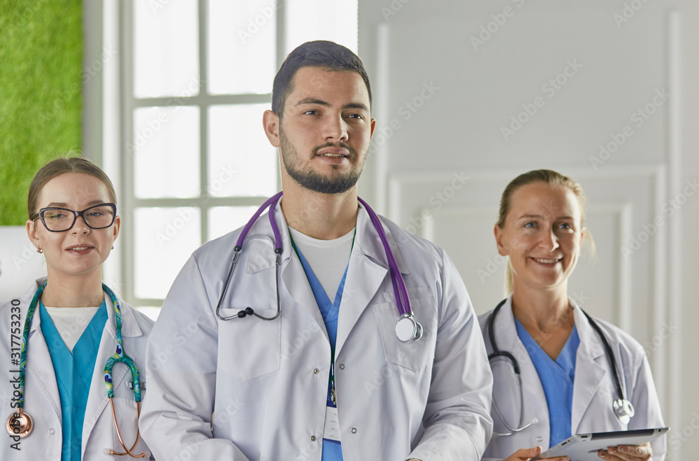 Portrait of group of smiling hospital colleagues standing together Portrait of group of smiling hospital colleagues standing together