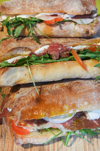 Ciabatta sandwich with wild rocket, prosciutto ham, tomatoes and mozzarella