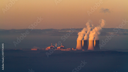 steam coming up from nuclear power plant in the morning photo