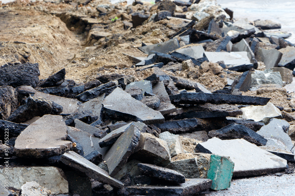 Pieces of broken asphalt. Road repair, close-up. Pieces of broken asphalt. Road repair, close-up.