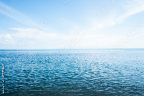 Blue sea with waves and sky with clouds. photo