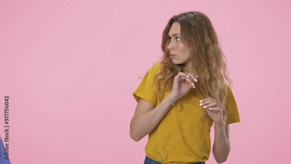 A pretty young woman pushes away a string bags with plastic waste isolated over pink background A pretty young woman pushes away a string bags with plastic waste isolated over pink background