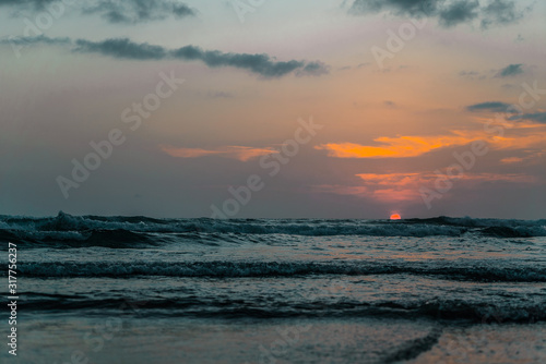 Sunset at a beach in Bali  Indonesia with waves