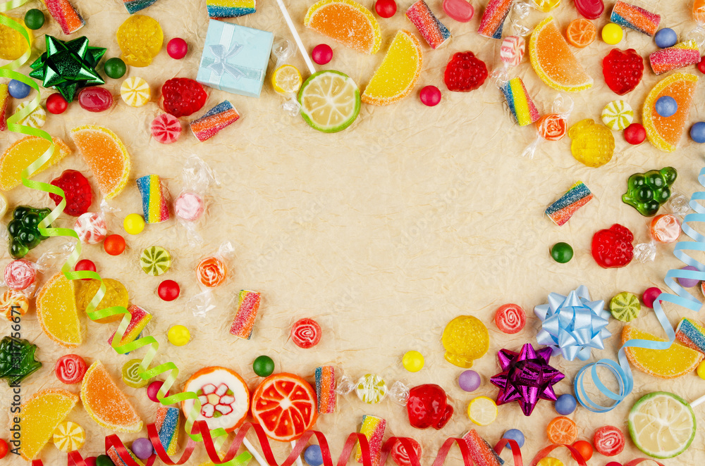 Flat lay view at frame made of different type color and taste candies on gold background. Space for text Flat lay view at frame made of different type color and taste candies on gold background. Space for text